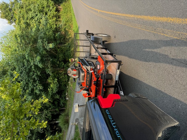 7x14 utility trailer loaded with a zero-turn mower